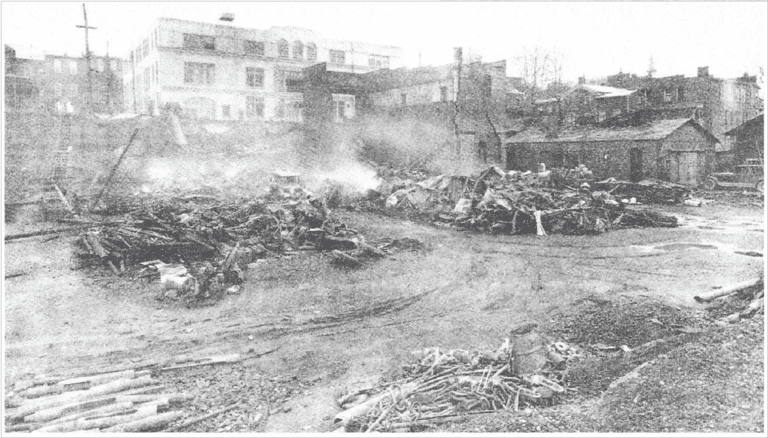The ruins of the wagon factory following the May 8, 1932 fire. The L.A. Leathers Garage, now the site of the Brookville Volunteer Fire Company hall, is visible in the background.