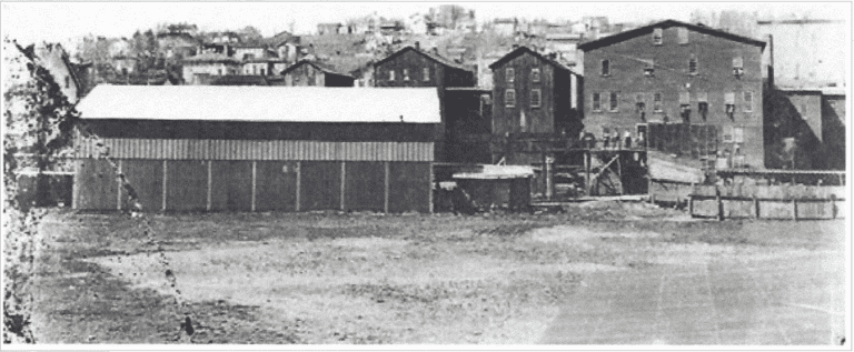 The Brookville Manufacturing Company produced farm wagons and other items from 1892 until 1918.This photo, taken in the early 1900s, shows the three story factory and several other buildings that once stood along Madison Avenue in Brookville. The old school may be seen at the top the hill.
